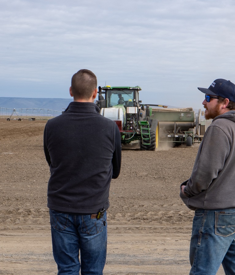 yara rep and farmer watching planting at incubator farm